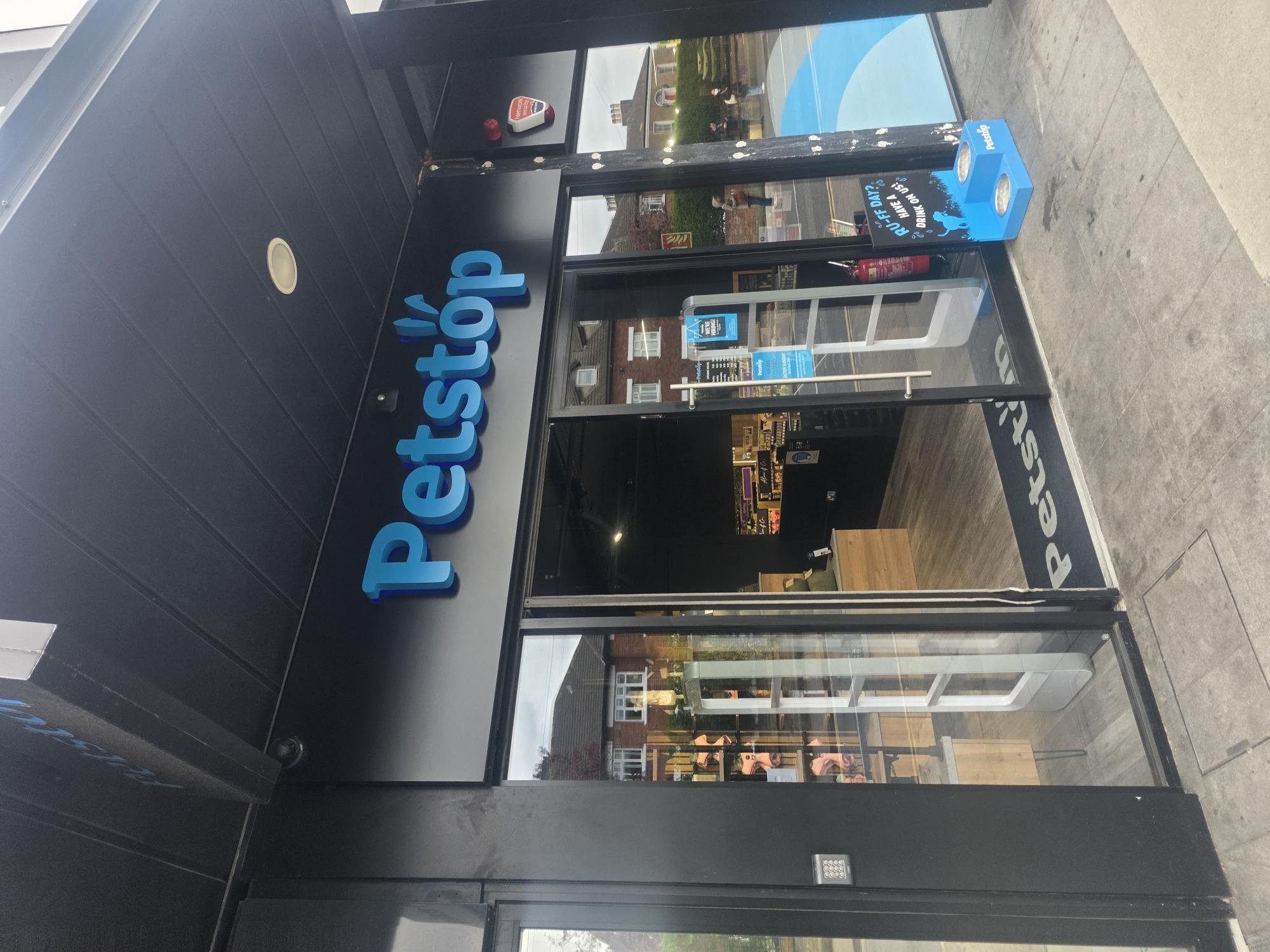 Petstop street-front store in Dublin, bright blue logo on black fascia with the &lsquo;RU-FF DAY?&rsquo; water bowl outside